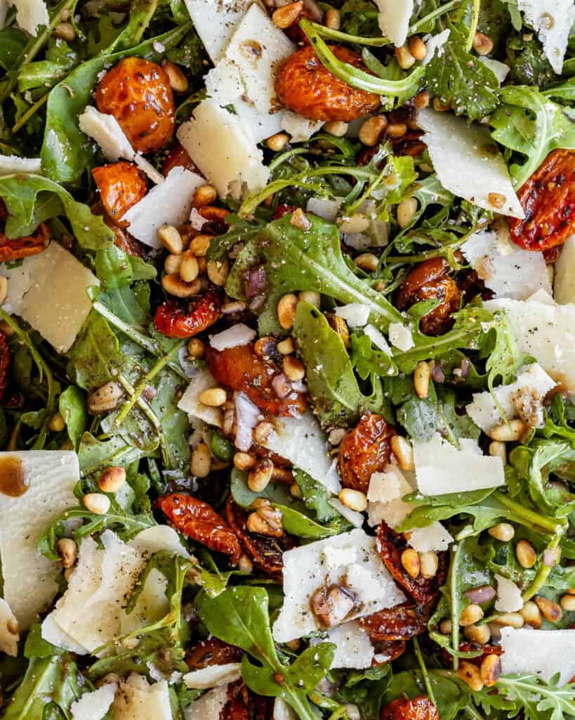 close up rucola salat med bagte tomater